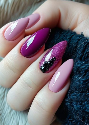 Elegant almond-shaped nails with glossy pastel pink and vibrant magenta designs, showcasing intricate details.