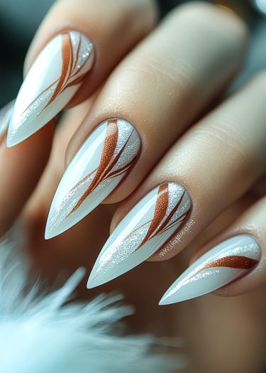 Elegant white stiletto nails with copper and silver designs for a luxurious manicure.