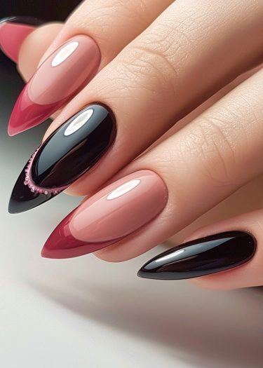 Elegant black and pink almond-shaped nails with ombre effect and delicate embellishments.