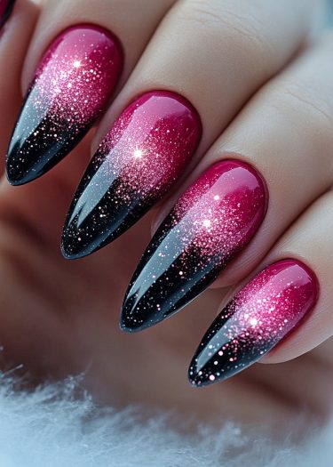 Sophisticated black and magenta ombre nails with glitter, showcasing elegant nail art design.