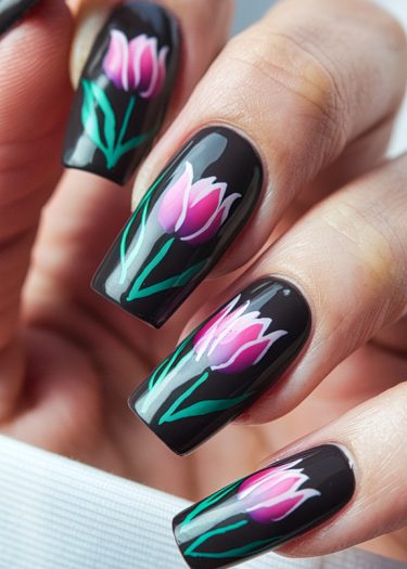 Elegant black floral nail art featuring pink tulips in a professional manicure design.