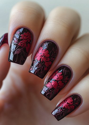 Elegant black nails with vibrant red floral designs showcase stunning nail art creativity.