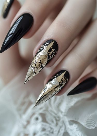 Elegant black stiletto nails with luxurious gold foil accents in a sophisticated design.