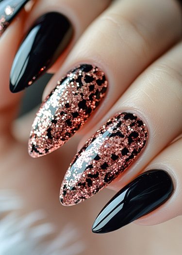 Stunning stiletto nails featuring black polish with luxurious rose gold leopard glitter accents.