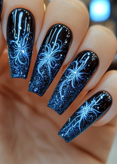 Elegant black coffin nails with intricate silver starburst designs and a cosmic shimmer.