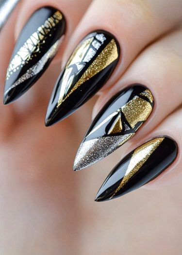 Elegant black nail art with gold and silver geometric designs for a chic, modern look.