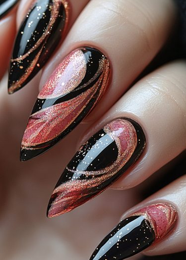 Elegant black and pink stiletto nails with glittery gold accents and a glossy finish.