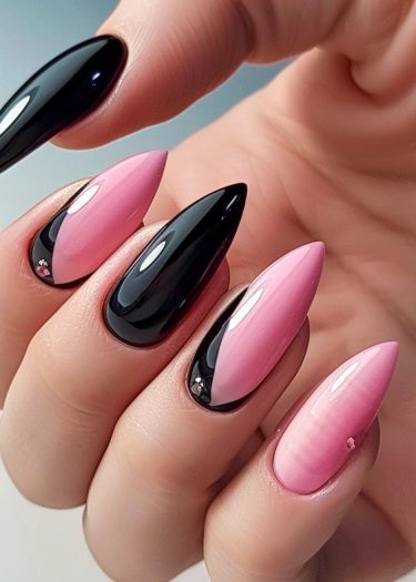 Elegant black and pink nail design with glossy finish and intricate floral rhinestones.