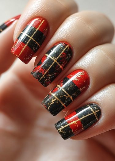 Elegant black and red tartan nail art with gold accents for a luxurious look.