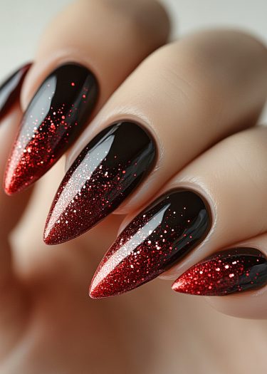 Elegant black and red ombre nails with stunning glitter create a bold, sophisticated look.