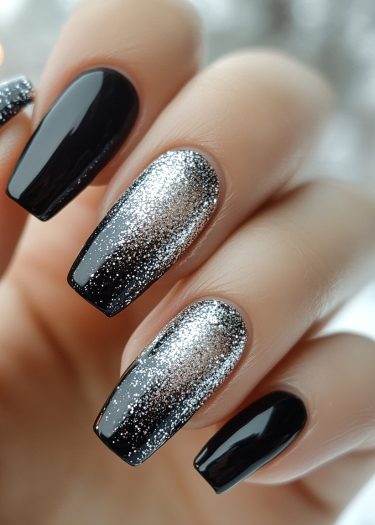 Elegant black and silver glitter coffin manicure with intricate designs and a high-gloss finish.