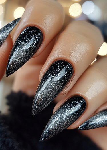 Stunning black and silver ombre stiletto nails with star accents for elegant nail art.