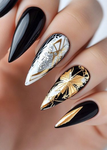 Elegant black and white nail art featuring intricate designs and luxurious stiletto shapes.