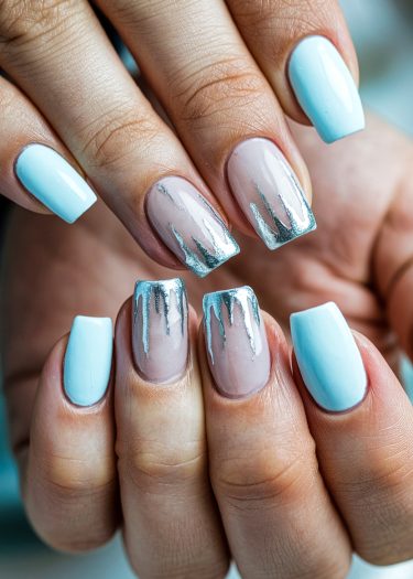 Stylish blue and metallic nail art featuring chic designs for elegant manicures.