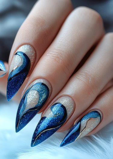 Elegant blue and silver glitter nail art on long almond-shaped nails.