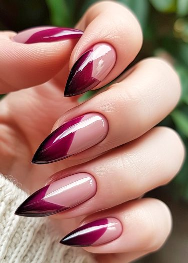 Elegant almond stiletto nails feature a burgundy-to-nude gradient with geometric accents.