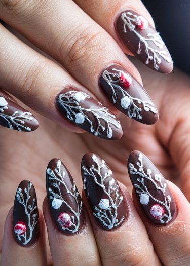 Elegant dark brown nail art with intricate floral designs in white and red.