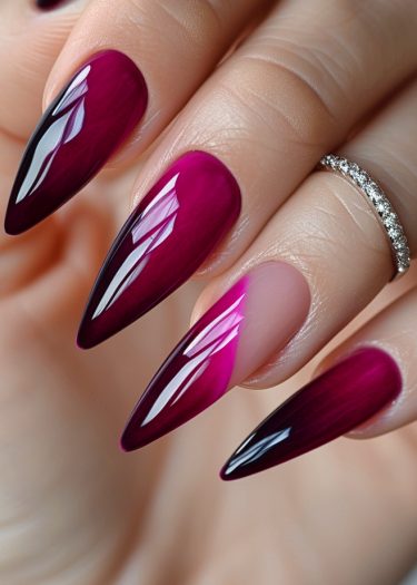 Elegant burgundy nail art with gradient design and sparkling ring for a sophisticated look.