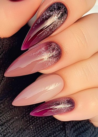 Elegant burgundy nails with gradient design and glitter accents for a sophisticated manicure look.