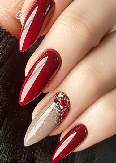 Elegant red almond-shaped nails with rhinestone accents showcasing high-fashion manicure design.