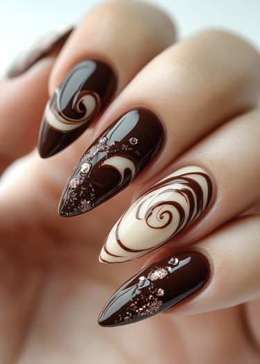 Sophisticated chocolate brown almond-shaped nails with marbling and glittering rhinestones.