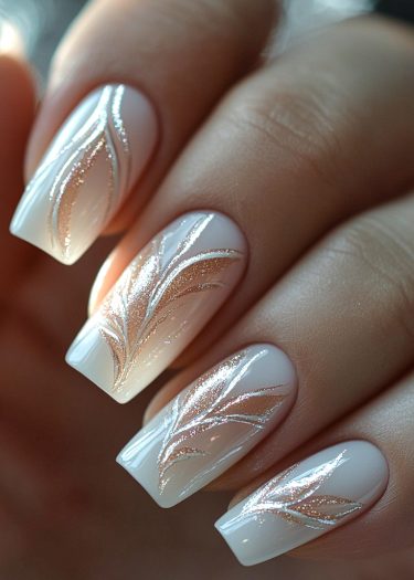 Elegant pale pink nails with glittery rose gold feather designs for sophisticated nail art.