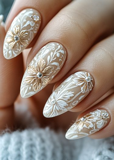 Elegant floral nail art with intricate white designs and golden embellishments for a refined look.