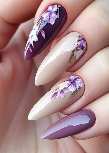 Chic burgundy and beige floral nail art with gold accents on elegant almond-shaped nails.