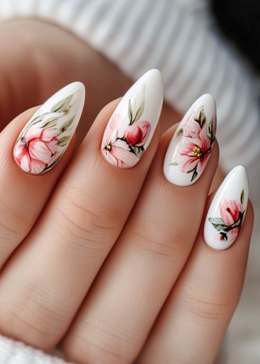 Elegant floral nail art featuring intricate pink flowers on almond-shaped white nails.