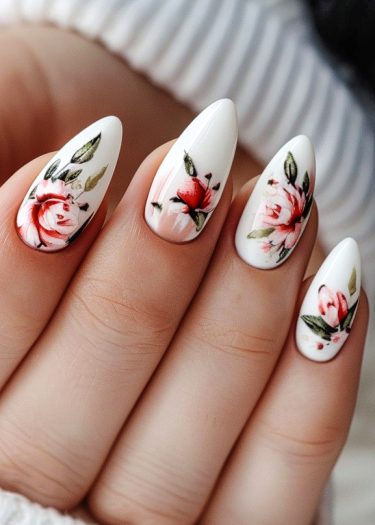 Elegant floral nail art featuring intricate roses on almond-shaped white nails.