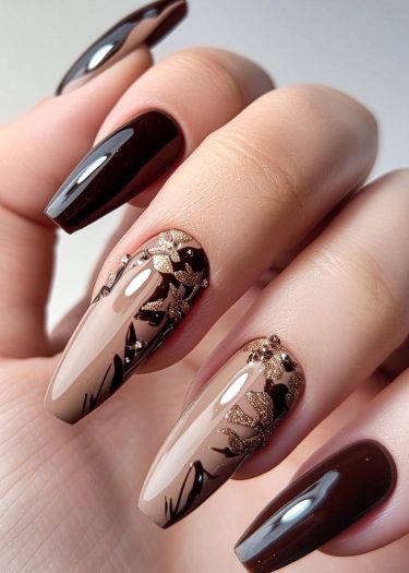 Elegant dark brown floral nail art with glossy beige accents and sparkling gold designs.