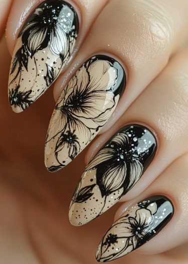 Elegant almond-shaped nails with intricate black floral designs on a soft beige background.