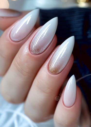 Elegant almond-shaped nails with a pink-white gradient and subtle glitter accent.