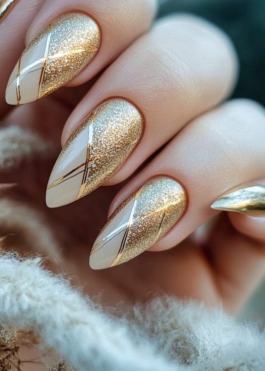 Elegant gold and white glitter nail design featuring intricate geometric patterns and almond shapes.