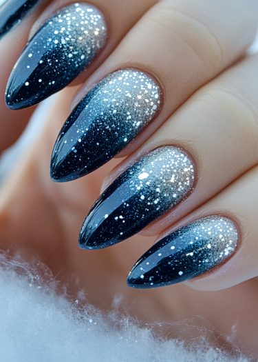 Stunning gradient nail art featuring midnight blue and silver with sparkling glitter accents.