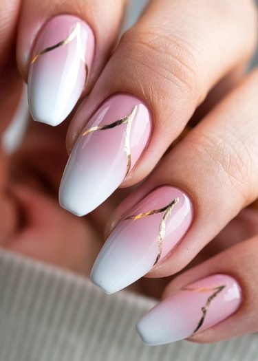 Elegant ombre nail art with gold accents, showcasing a sophisticated design and polished finish.