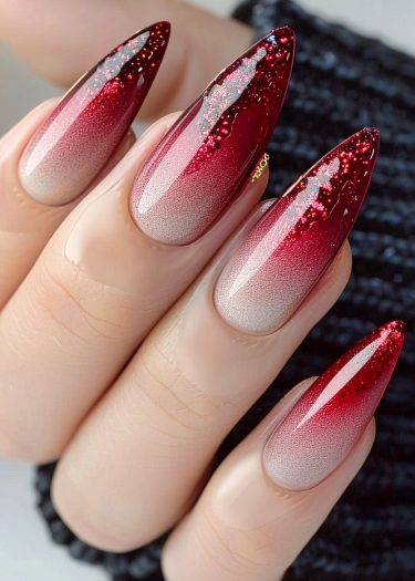 Elegant stiletto nails with ombre design and glitter accent in burgundy and nude.