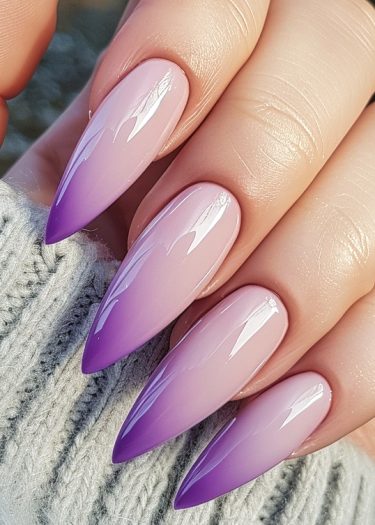 Elegant stiletto nails with a beautiful lilac-to-purple gradient and glossy finish.