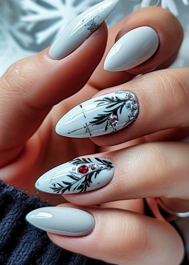 Elegant gray almond nails with intricate designs and glimmering embellishments for a chic winter look.