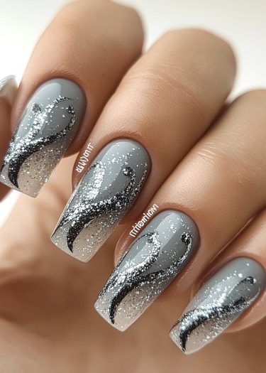 Elegant gray nail design with glitter and intricate black patterns for a chic look.