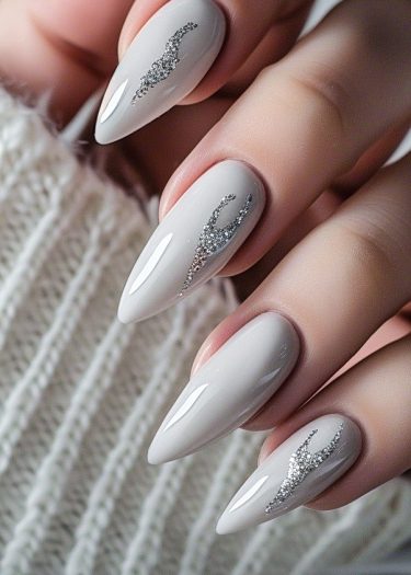 Glamorous stiletto gray nails with silver embellishments, perfect for elegant occasions.