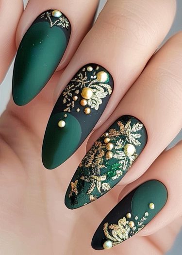 Elegant almond-shaped nails feature intricate gold floral designs on a matte forest green base.