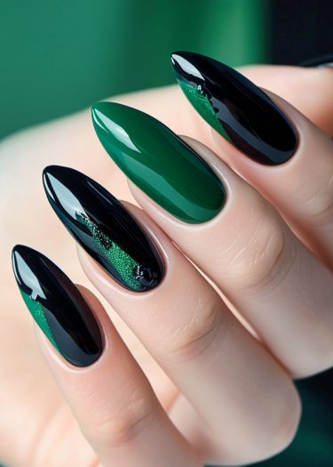 Elegant green and black manicure with intricate designs on beautifully shaped nails.