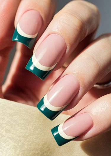 Elegant pink and teal French tips showcase stylish, sophisticated nail art on manicured nails.