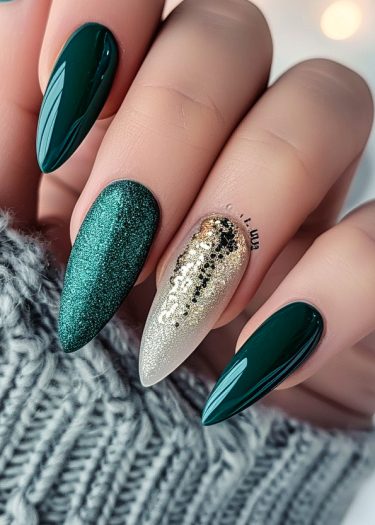 Stunning green and gold glitter stiletto nails for an elegant and festive manicure.