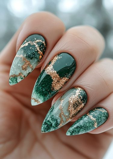 Elegant green and gold stiletto nails with a stunning gradient design and shimmering foil accents.