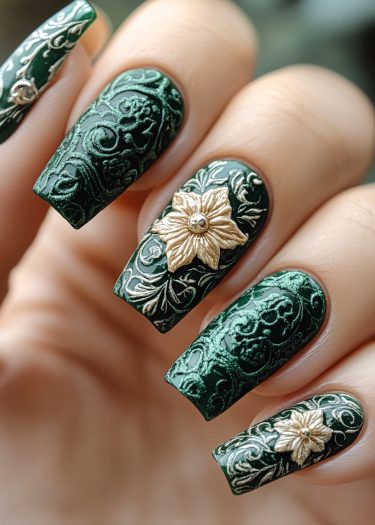 Elegant green nail art featuring gold floral motifs and intricate embossed patterns for a luxurious look.