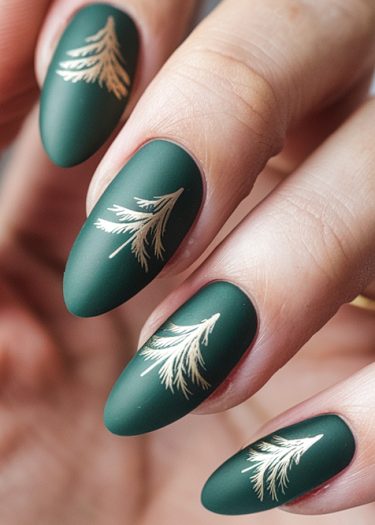 Elegant matte green nail art with gold botanical designs on almond-shaped nails.