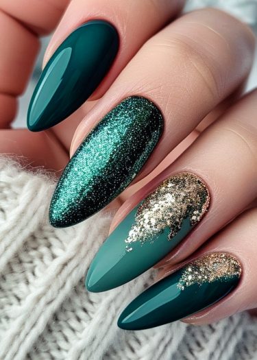 Elegant green nail art featuring glitter and gold leaf designs on manicured oval nails.