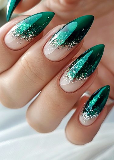 Elegant green gradient nail art with glitter and almond tips for a glamorous look.